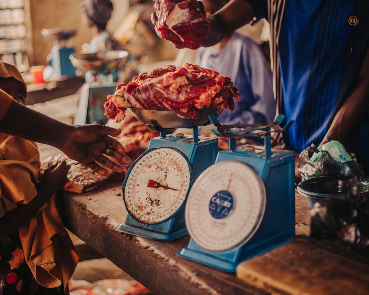Fresh meat being weighed on blue market scales