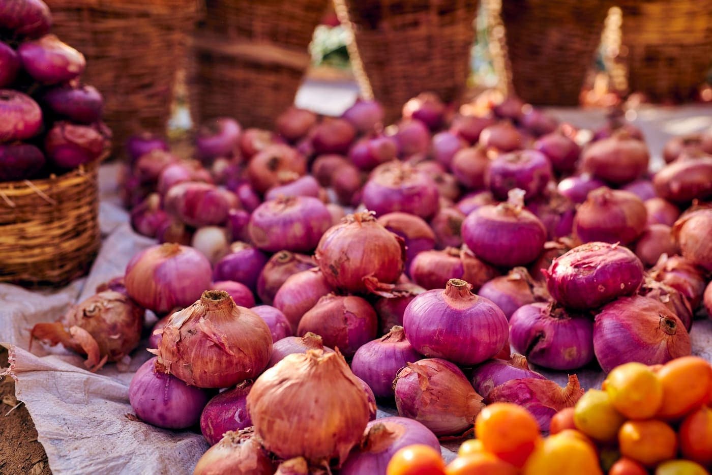 Heaps of red onions at a vegetable market