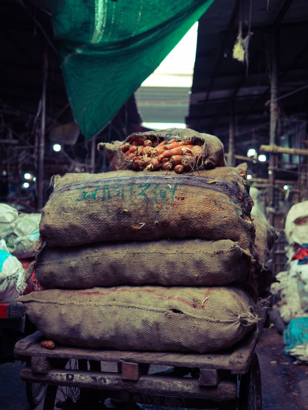 Stacked sacks of produce at a wholesale bazar