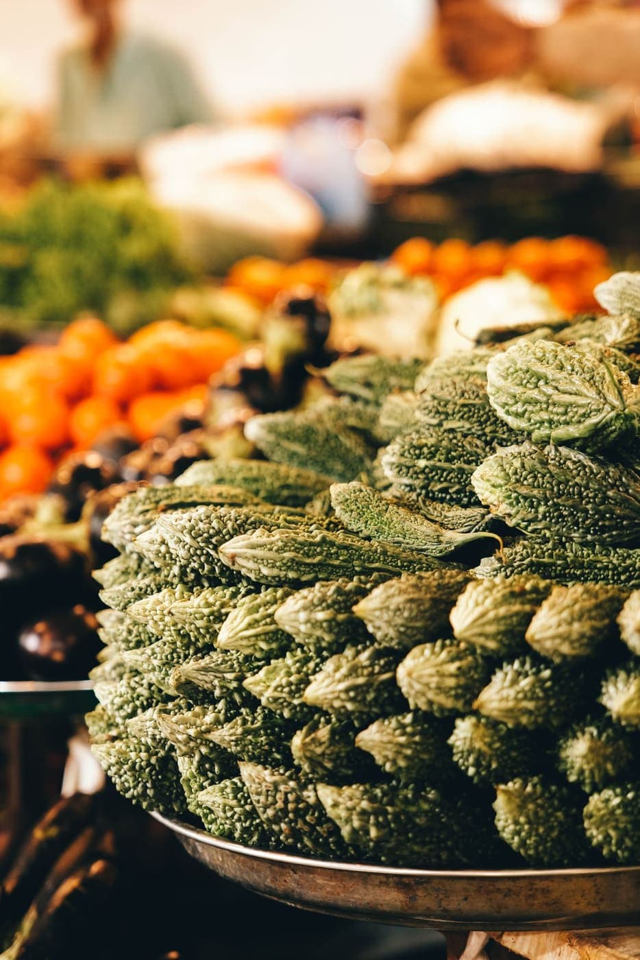 A stack of bitter gourds at a vegetable market
